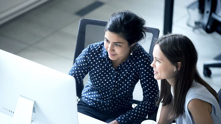 advisory and consulting two women looking at screen.png