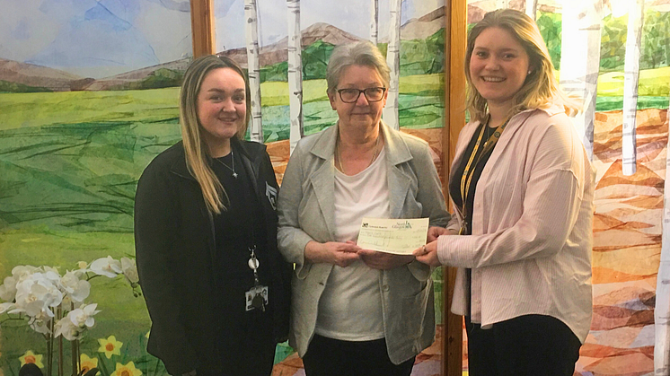 ng home Chairperson Catherine Rossine presents Marie Curie donation 
