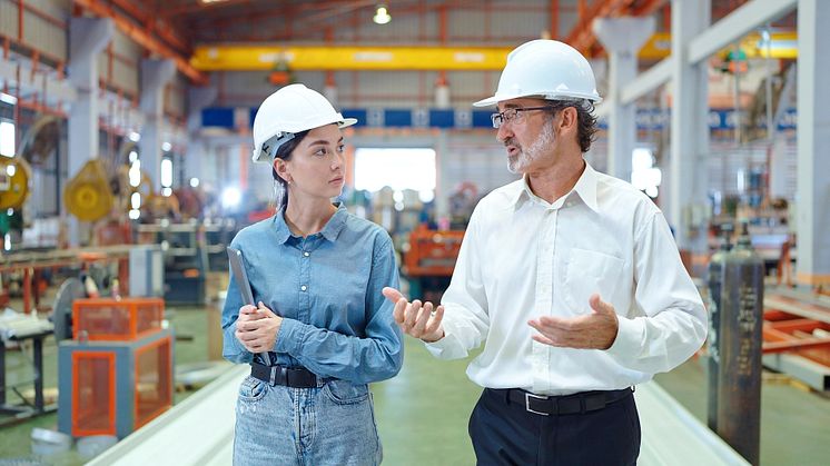 Man and woman in factory hall - M Stocker_shutterstock_2287975659.jpg