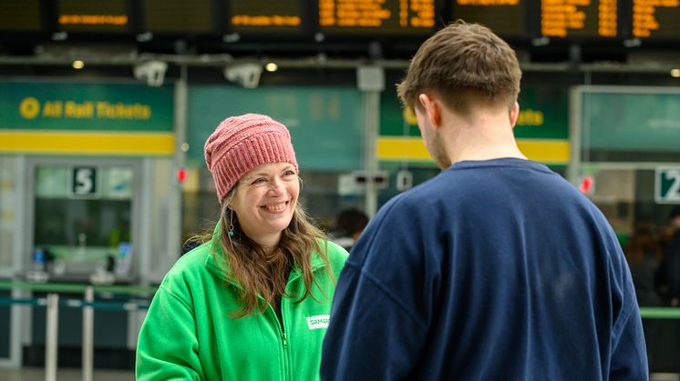 A Samaritans volunteer chatting to a member of the public. Image was taken in 2023