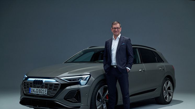 AUDI AG CEO Markus Duesmann foran Audi Q8 e-tron (Chronosgrå)