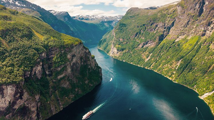 A Hurtigruten ship traveling through the Geirangerfjord in Norway. 