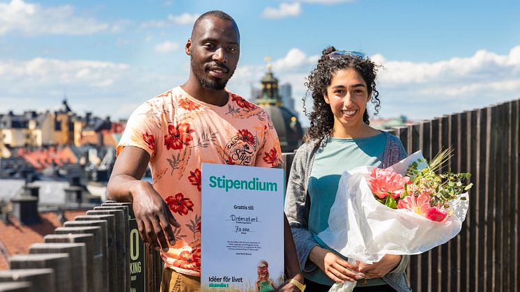 Kassim Nagwere grundare och verksamhetschef och Fereshteh Mojaverian projektledare i föreningen Drömstort tar emot blommor och värdebevis på Skandia Fastigheters takpark på Sveavägen 44 i Stockholm. 