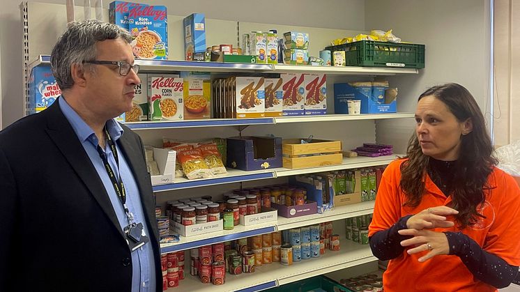 Katie Jenkinson from the Trust House shows Cllr Gold how the food pantry works and explains about the other services Trust House provides