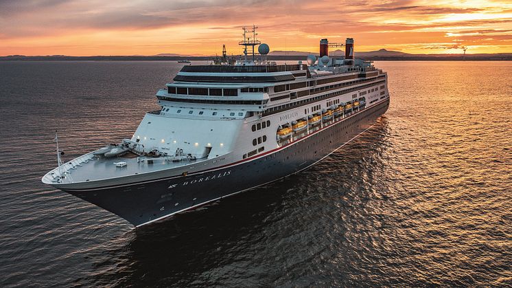 Borealis at sea at sunset