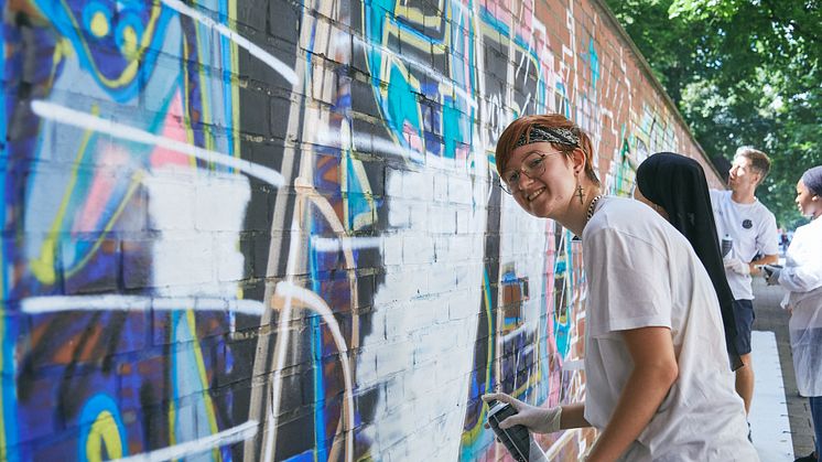 Jugendliche sprayen eine Botschaft 