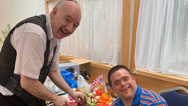 Pictured is Jonny Wineberg from Jewish Action for Mental Health demonstrating how to cook on a budget with Friendship Circle member Ellis Leigh