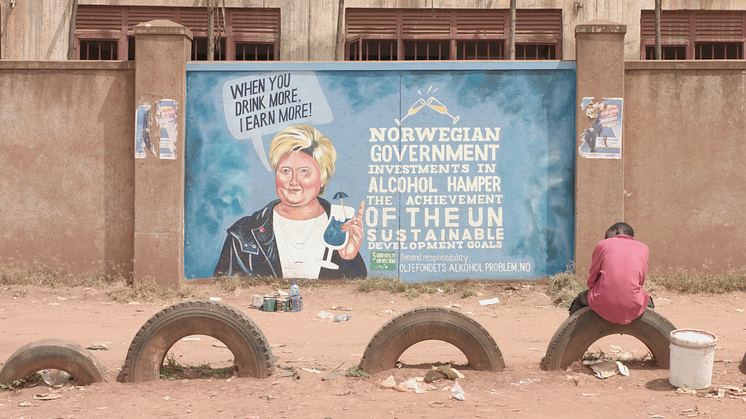 Erna Solberg på en vegg i Uganda