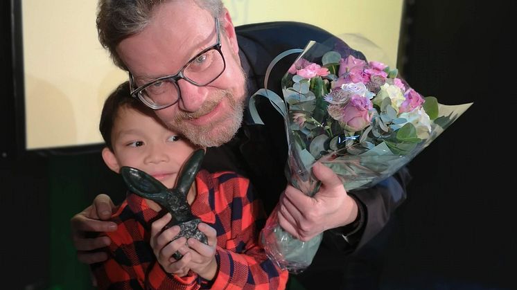 Steffen Kverneland fikk Bibliotekets litteraturpris onsdag kveld for den selvbiografiske tegneserien «En frivillig død». Sønnen Aksel tok vare på statuetten, formet av kunstneren Kjell Erik Killi Olsen. Foto: Jørn Johansen, Deichman. 