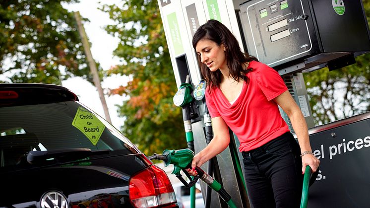 Motorist filling up at fuel station