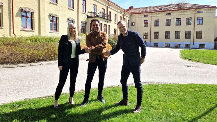 Josefine Nordström, avdelningschef Lokal och Daniel Ruus, Fastighetsutvecklingschef på Eidar skakar hand med Arvin Yarollahi, VD och verksamhetschef för Specialistläkarna. Stavregården i bakgrunden ska byggas om till center för specialistvård.