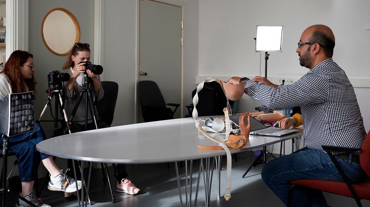 Mohammad Sobuh, assistant professor and prosthetist/orthotist, demonstrates alternative designs of arm prostheses. Behind the camera is Ukrainian film crew Anna Borysova and Anna Vialova.