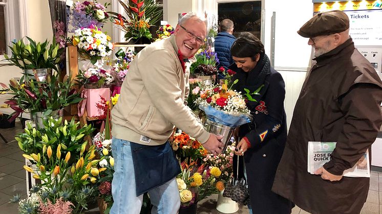 Gavin Lambert (left) serves customers at his new florist’s shop at Horley station