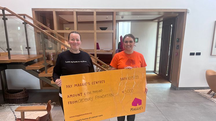 Mondelēz International employee Jemma and Maggie’s Wirral worker holding the cheque from The Cadbury Foundation