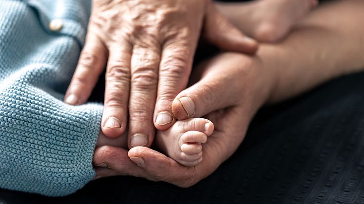 feet-newborn-baby-hands-grandmother-closeup
