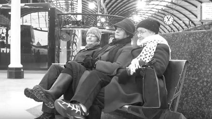 Three members of Grand Gestures Dance Collective sitting