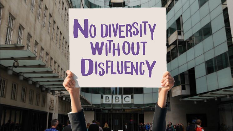 Hands holding placard reading 'No Diversity Without Disfluency'