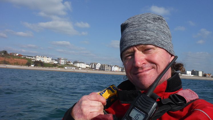 Roy Beal with the Ocean Signal rescueME PLB1 which he will carry on his 900-mile Top Down Kayak Challenge. Photo credit: Roy Beal