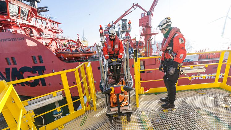 Transfer of specialists, tools and parts from 'Esvagt Froude' to a wind turbine by Ampelmann walk to work gangway.