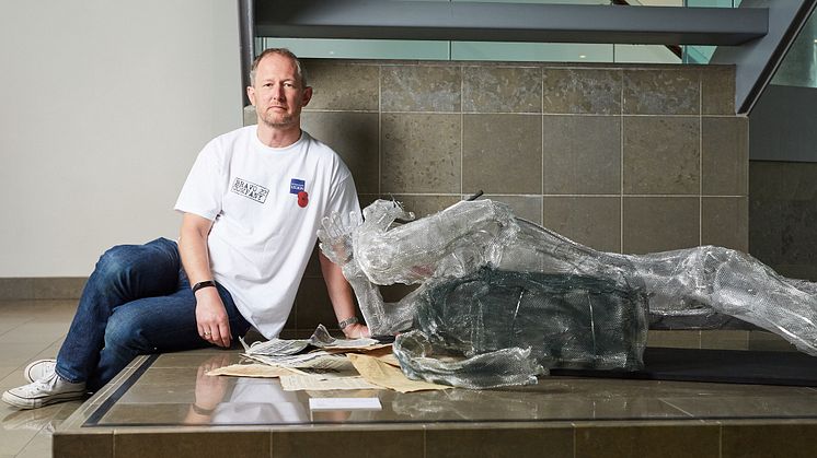 Stewart Hill with his sculpture, on show at Bury Art Museum