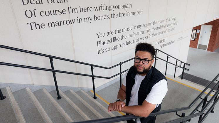 Casey Bailey with the "Dear Brum" art installation at University station in Birmingham