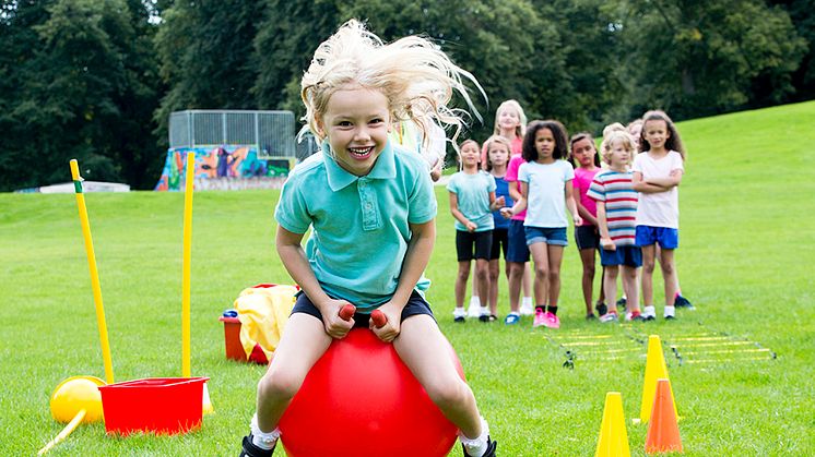 girl playing in school field