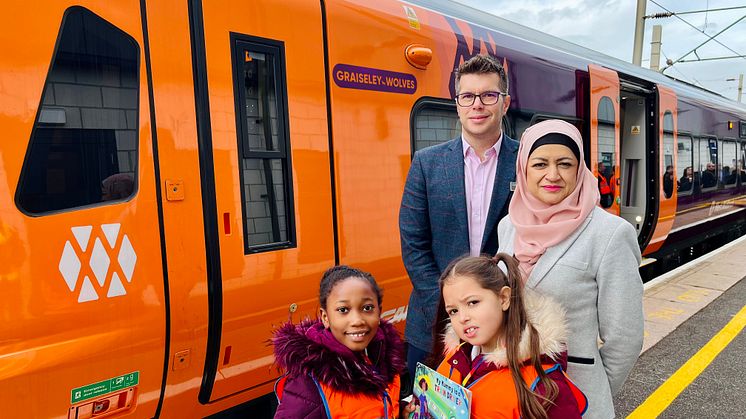 WMR customer experience director Jonny Wiseman, head teacher Sharifan Nasa and school children with the Graiseley Wolves train