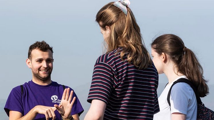 A National Deaf Children’s Society staff member using sign language to communicate