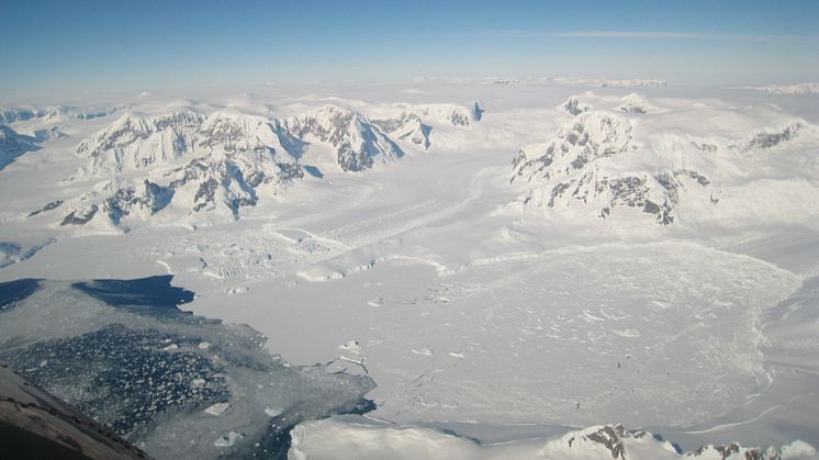 Ice on the Antarctic peninsula flowing along a channel into an ice shelf in the ocean. Hilmar Gudmundsson