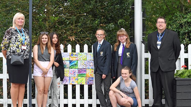 Head of Stations Angie Palmer and Station Manager David Hughes join students from Downham Market Academy who are displaying their art at the station (you can download more pictures below)