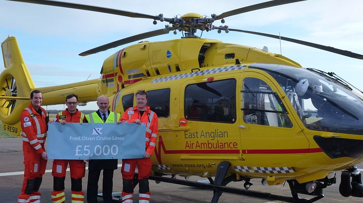 The crew of the East Anglian Air Ambulance receive the Fred. Olsen Social Engagement Group’s donation of £5,000 from Mike Rodwell, Fred. Olsen Cruise Lines’ Managing Director (2nd from right), at its airbase at Cambridge Airport. 