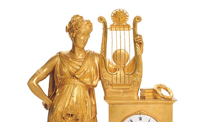 A large French Empire gilt bronze mantel clock