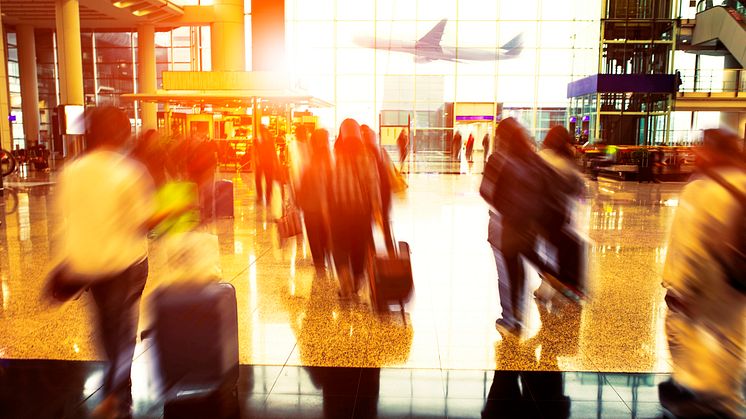 32726063-people-with-traveling-luggage-walking-in-airport-terminal