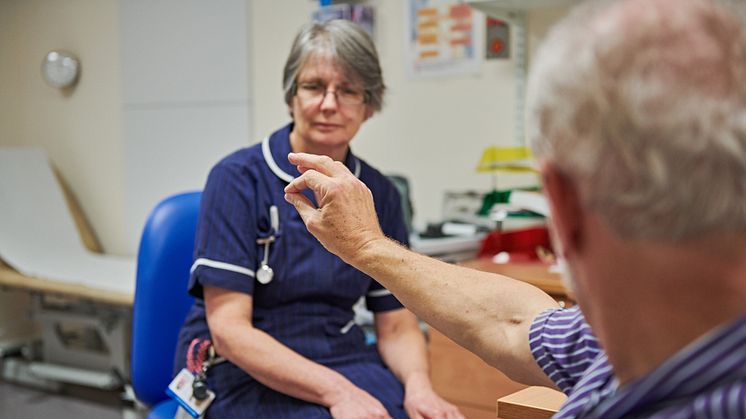 A Parkinson's Nurse working with a patient