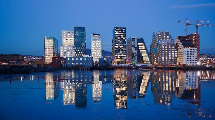 Skyline of Oslo at night reflecting in water