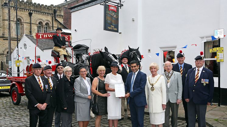 Council leader Rishi Shori presents the FAB award to Jane Lord and Jacqui Gallagher outside the Two Tubs.