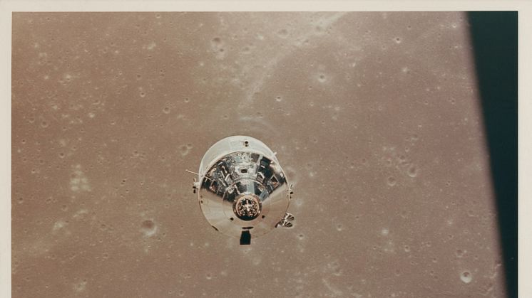 The CSM Columbia over the Sea of Fertility, as seen from the LM descending to the lunar surface.jpg
