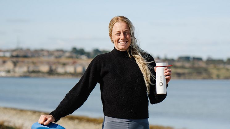 Ellie Aldridge with board and bottle