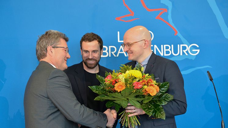 Thomas Kralinski (r.), Chef der Potsdamer Staatskanzlei, beglückwünscht Oculyze-Geschäftsführer Kilian Moser und Team-Berater Prof. Dr. Marcus Frohme (l.) zur Auszeichnung.