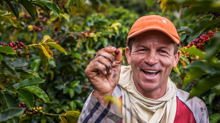 colombian-farmer-showing-a-coffee-cherry_52371621778_o