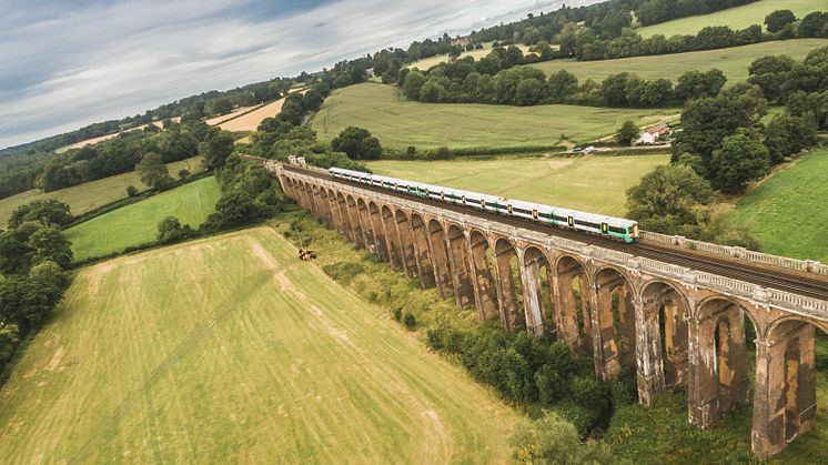 A Southern train cruises over the Ouse Valley Viaduct