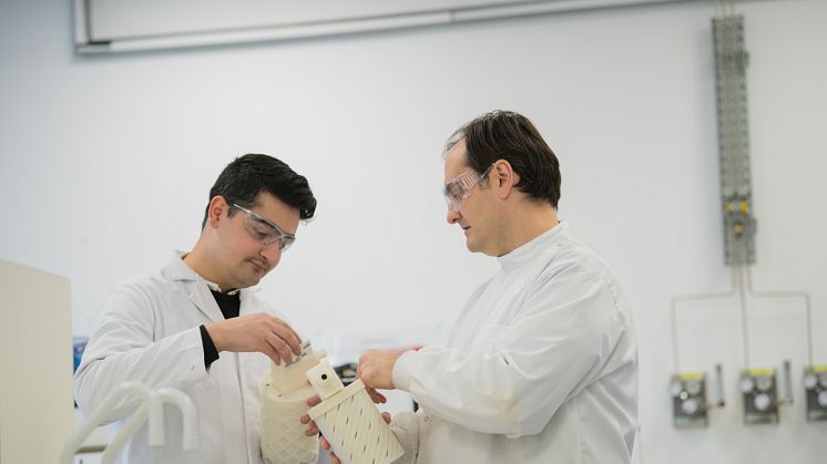 Design Engineer Saqib Ali and Dr Sterghios Moschos look at a prototype of the innovative breath collecting device