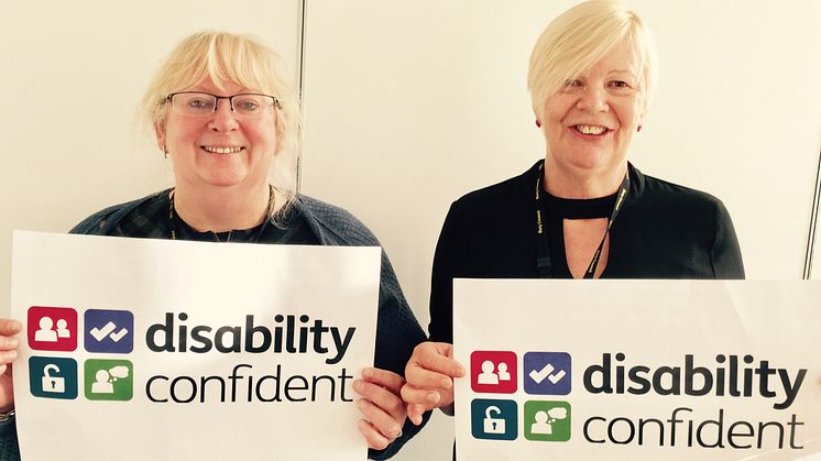With the accreditation logo are Diane Halton and Cllr Catherine Preston, co-chairs of the council’s disabled employees group.