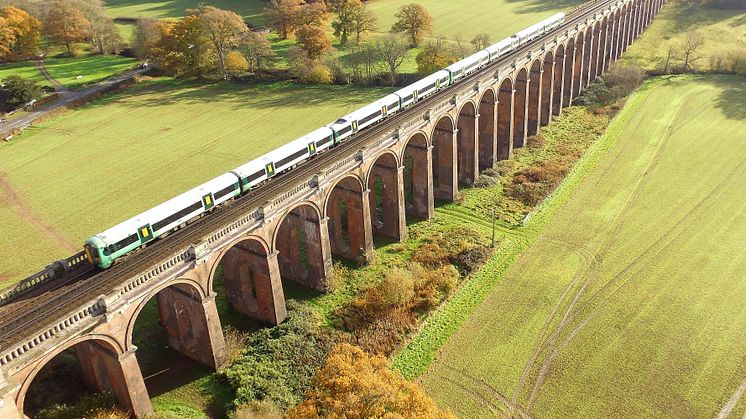 A Southern train passes over Ouse Valley Viaduct