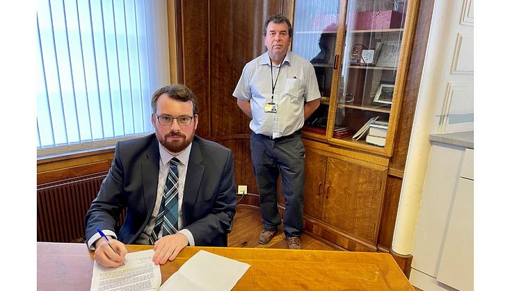 Council leader Eamonn O’Brien (seated) signs the joint GM letter on behalf of Bury, with (back) Cllr Alan Quinn.