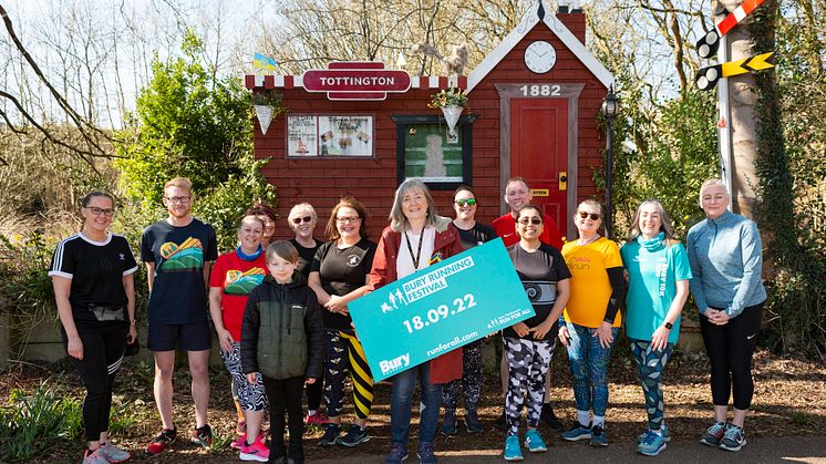 Cllr Debbie Quinn and local running champions, taken at the mock railway station on The Lines at Kirklees Trail in Tottington.