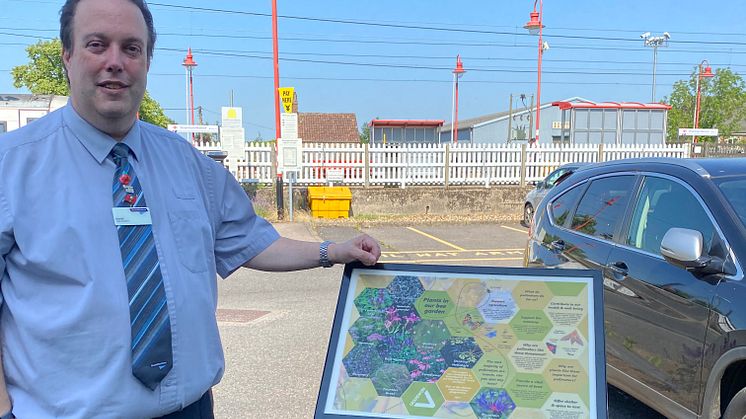 Station booking office clerk Darrell Gardiner is delighted with the new bee garden which features this information board (more pictures below)
