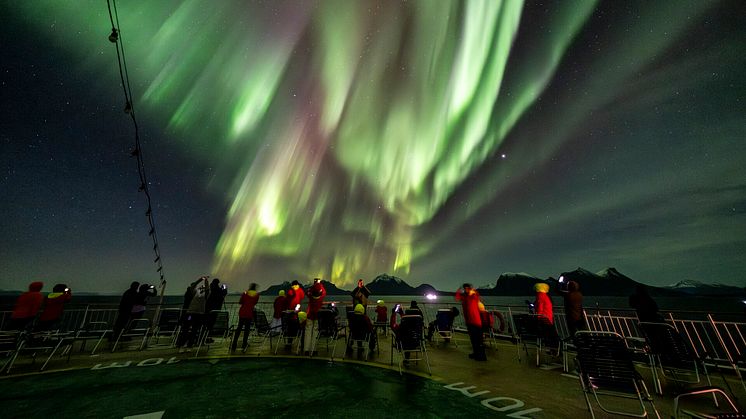 Guests onboard Hurtigruten's Original Coastal Express enjoying the Northern Lights. Photo: Tommy Simonsen