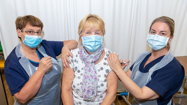 At the double – Shirley Holden gets her Covid booster and flu jabs from vaccination team members Julie Taylor and Nicola Battle.