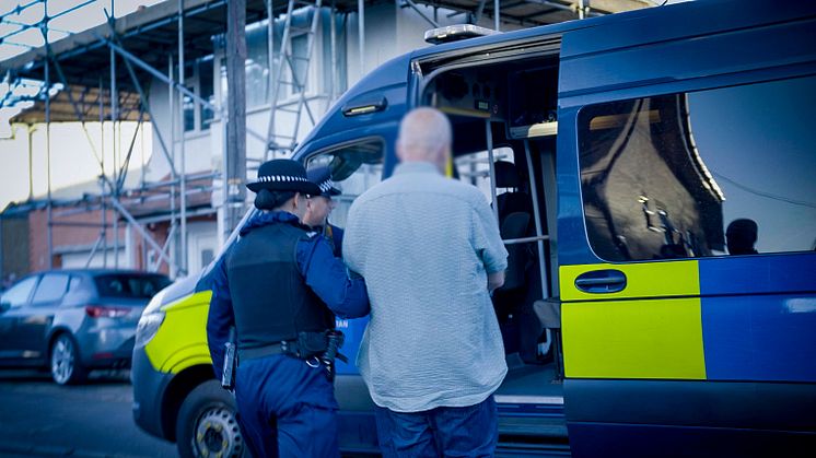 Officers arrest a man on suspicion of violent disorder at an address in Sutton.jpg